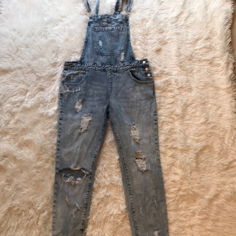 Ripped blue jean overalls